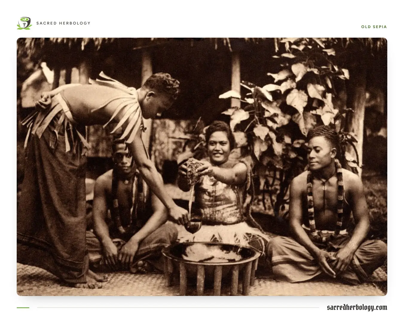 Old sepia photograph of a young Samoan woman seated at a many-legged wooden bowl between two seated men, with a man standing beside them holding a cup