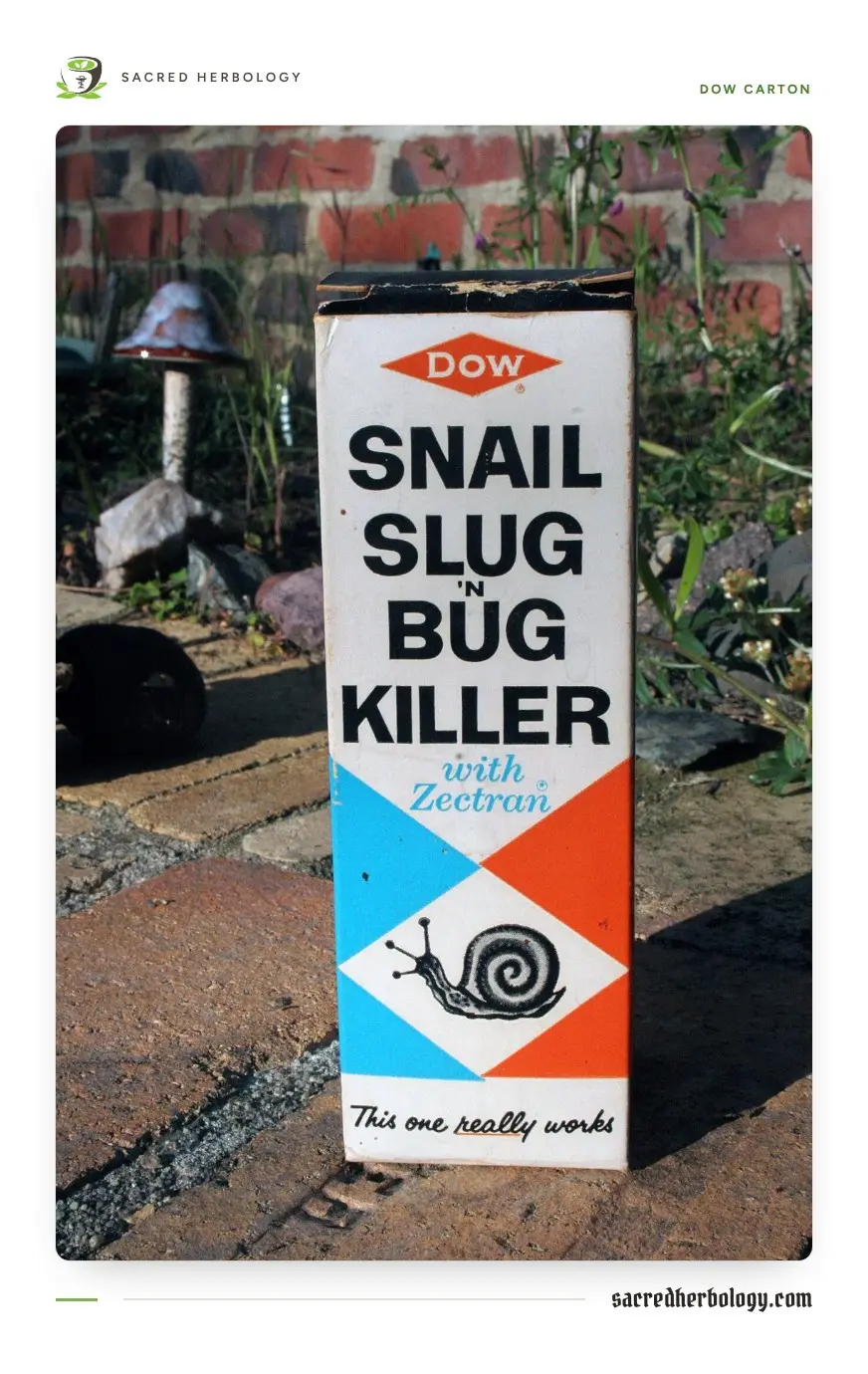 An old upright Dow carton reading Snail, Slug 'n Bug Killer with Zectran, standing on bricks in a garden